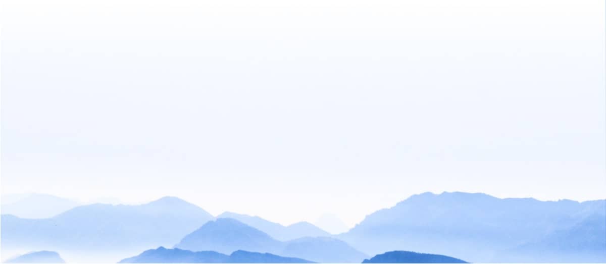 Peaceful blue mountains are seen off in the distance. 